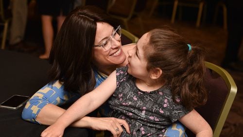 Dr. Rebecca Oberman enjoys a moment with Eden Gold, a 10-year-old from Atlanta who was diagnosed with ML4 in 2009. Oberman is executive director of the ML4 Foundation, which hosted its annual ML4 International Research Conference June 24 in Atlanta. CONTRIBUTED BY BETH INTRO PHOTOGRAPHY