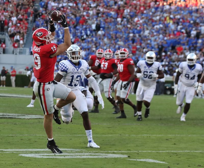 Georgia tight end Brock Bowers catches a touchdown pass from Stetson Bennett past Kentucky defender JJ. Weaver to take a 30-7 lead during the fourth quarter Saturday, Oct. 16, 2021, in Athens. (Curtis Compton / Curtis.Compton@ajc.com)