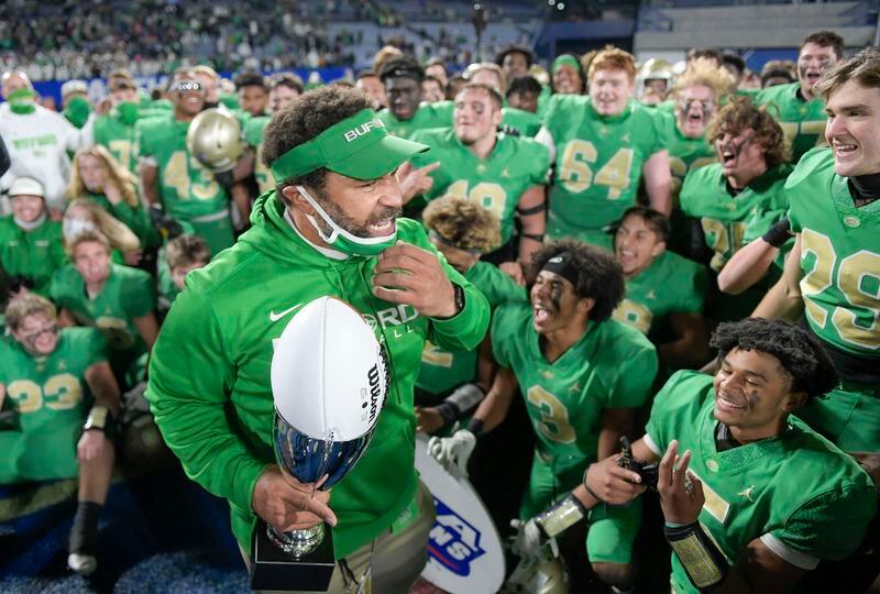 Buford head coach Bryant Appling holds his championship trophy after beating Lee County 34-31 in a Class 6A state high school football final Tuesday, Dec. 29, 2020, at Center Parc Stadium in Atlanta. (Daniel Varnado/For the AJC)