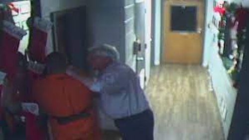 Chief Magistrate Cary Hays III pinning defendant against a wall in a courthouse hallway in December 2020. (Photo courtesy of Channel 2 Action News)