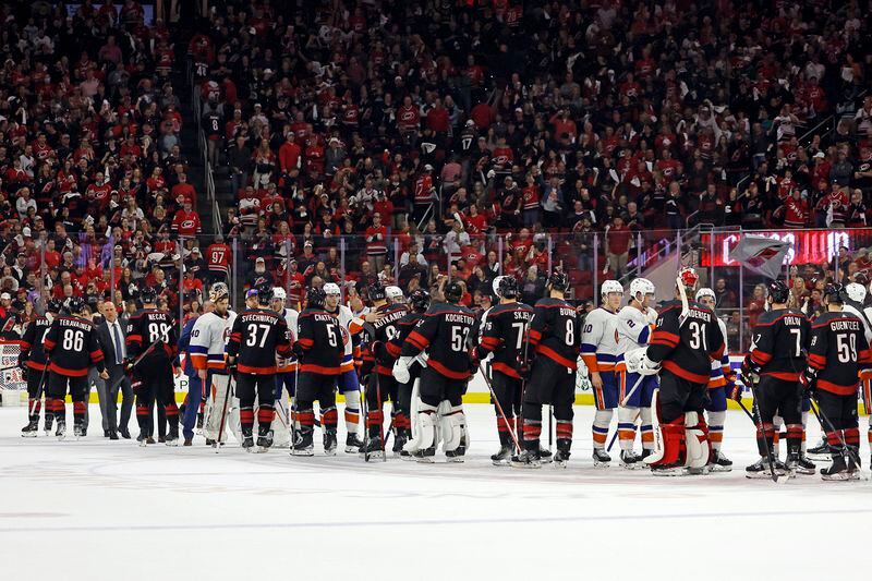 New York Islanders and the Carolina Hurricanes shake hands following the Hurricanes win at the NHL hockey Stanley Cup first-round playoff series in Raleigh, N.C., Tuesday, April 30, 2024. (AP Photo/Karl B DeBlaker)