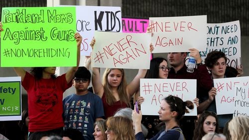 Protesters attend a rally at the Federal Courthouse in Fort Lauderdale, Fla., to demand government action on firearms, on Saturday, Feb. 17, 2018. Their call to action is a response the massacre at Marjory Stoneman Douglas High School in Parkland, Fla. (Mike Stocker/Sun Sentinel/TNS)