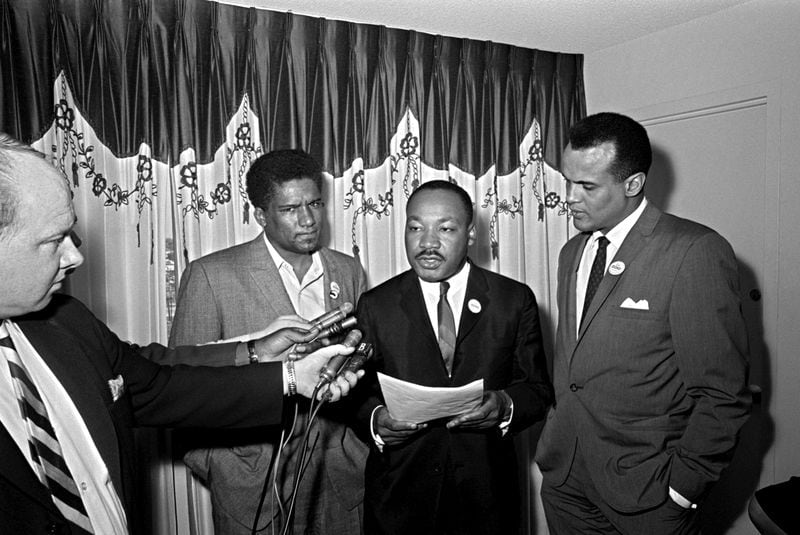 James Forman, executive secretary of the Student Non-Violent Coordinating Committee, Dr. Martin Luther King Jr., center, and singer/activist Harry Belafonte, right, are interviewed. (Horace Cort/ AP Photo)