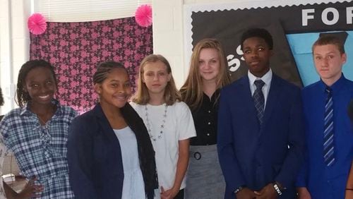 Business education and computer science students show off their professional attire on Dress for Success Wednesdays at Flat Rock Middle. Pictured (l-r) are Lourdes Cervantes-Dixon, Fatoumata Diallo, Kaniya Robinson, Crista Lewis, Lindsey Tapp, John Phillips, Joshua Wilkerson and Tyra Blake.