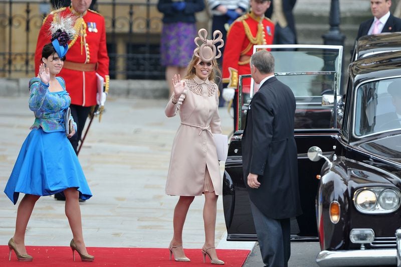 LONDON, ENGLAND - APRIL 29:  Princess Beatrice of York and Princess Eugenie of York (L) prepare to make the journey by carriage procession to Buckingham Palace following the Royal Wedding of Prince William, Duke of Cambridge and Catherine, Duchess of Cambridge at Westminster Abbey on April 29, 2011 in London, England. Beatrice’s hat, called a fascinator, made headlines. Photo by Pascal Le Segretain/Getty Images