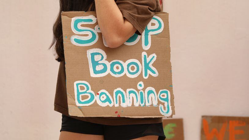 A student holds a sign that reads "Stop Book Banning" at a rally at the Orange County school board meeting in Orlando, Fla., on April 11, 2023. (Carolyn Cole/Los Angeles Times/TNS)