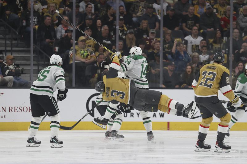 Dallas Stars left wing Jamie Benn (14) checks Vegas Golden Knights defenseman Brayden McNabb (3) during the first period in Game 4 of an NHL hockey Stanley Cup first-round playoff series Monday, April 29, 2024, in Las Vegas. (AP Photo/Ian Maule)