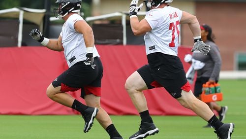 Rookie linemen on the move: Top draft pick Chris Lindstrom (left) and Kaleb McGary race across the field to the next drill. (Curtis Compton/ccompton@ajc.com).