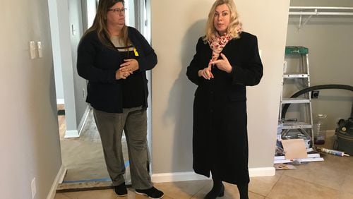 Ingrid Buxbaum, right, stands in a home she is renovating in the Starlight Heights neighborhood in DeKalb County on Jan. 16, 2019, and speaks to neighbor Debbie Joudeh about concerns they have about the park land swap proposed by Blackhall Studios. (TIA MITCHELL/TIA.MITCHELL@AJC.COM)