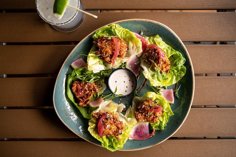 UP on the Roof's shareable plates include Honey-Soy Fried Chicken Lettuce Wraps with herbed goat cheese ranch. (Mia Yakel for The Atlanta Journal-Constitution)
