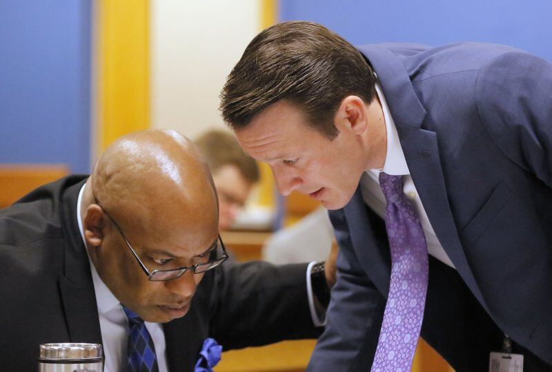 Aug. 25, 2017 - Atlanta, GA - Prosecutors Clint Rucker (left) and Adam Abbate confer during hearing in Fulton Superior Court Friday. Claud “Tex” McIver faces murder charges in the shooting death of his wife, which he says was an accident. A judge weighed whether to grant McIver freedom from jail to visit his dying mother. . BOB ANDRES /BANDRES@AJC.COM