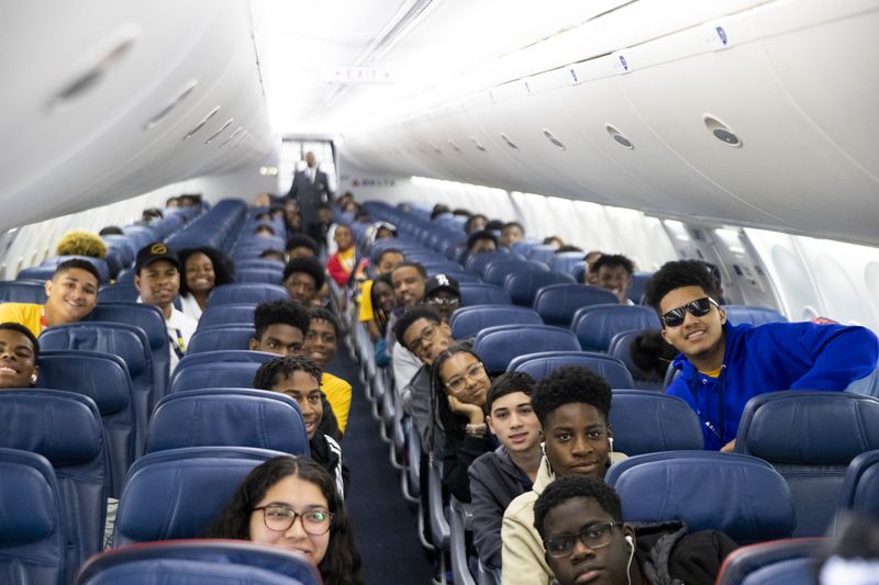 Participants of Delta’s Dream Flight 2022 pose for a photo aboard a plane at Hartsfield-Jackson Atlanta International Airport on Friday, July 15, 2022. Around 150 students ranging from 13 to 18 years old will fly from Atlanta to the Duluth Air National Guard Base in Duluth, Minnesota. (Chris Day/Christopher.Day@ajc.com)
