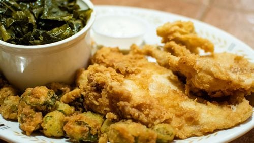 The fried catfish plate at Vittles comes with a salad and two sides, shown here with collard greens and fried okra.
