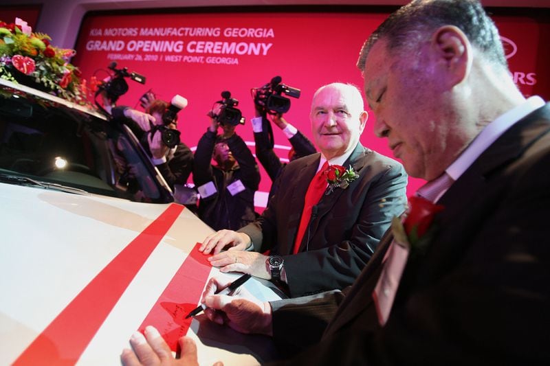Then-Gov. Sonny Perdue, center, shown at the ceremonial opening of the Kia plant in West Point in 2010, considered the automaker's decision to come to Georgia a crowning achievement of his administration.