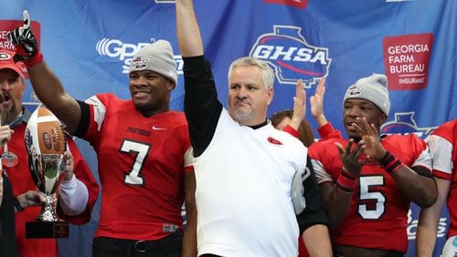 Clinch County coach Jim Dickerson, center, celebrates with Trezmen Marshall (7) and Dantonio Robinson (5) after they defeated Irwin County 27-20 in the Class A public championship at Mercedes-Benz Stadium Tuesday, December 11, 2018, in Atlanta. (JASON GETZ/SPECIAL TO THE AJC)