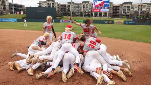 Loganville players celebrate after Angel Quezada hit the game-winning walkout single against Cartersville in game three of the Class 5A GHSA baseball finals at Coolray Field, Friday, May 17, 2024, in Lawrenceville, Ga. Loganville won 4-3. (Jason Getz / AJC)

