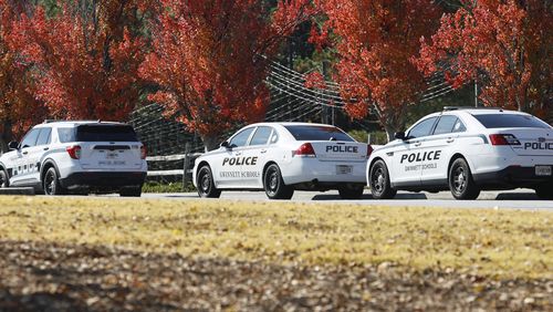Views of multiple police cars parked near the front entrance of Norcross High School on Thursday, October 27, 2022. The school has increased police presence after a student was fatally shot near the campus. (Natrice Miller/natrice.miller@ajc.com)  