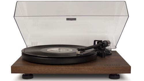 The Crosley C6 two-speed manual turntable looks great in a walnut-colored veneer shell, with an acrylic folding lid. Other choices are black or red. (Handout/TNS)