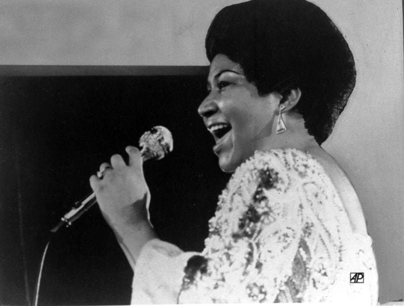 FILE - In this Jan. 28, 1972 file photo, vocalist Aretha Franklin sings a few notes into microphone. Franklin contributed often to social justice issues, especially those in the black community.  (AP Photo)