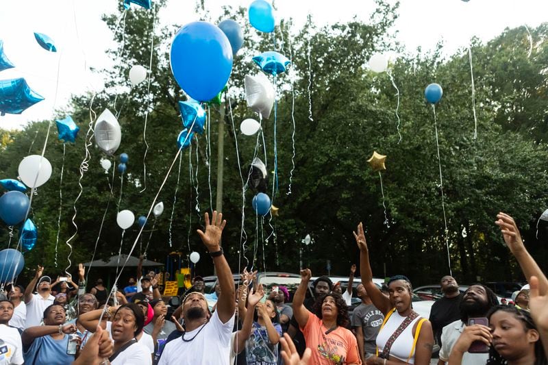 Family and friends release balloons in the air during a vigil and balloon release for Johnny Hollman on Tuesday, August 15, 2023, at Mary Shy Scott Park in Atlanta. Hollman died after he became unresponsive during an encounter with Atlanta police. (Michael Blackshire/Michael.blackshire@ajc.com)