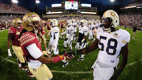 ATLANTA, GA - OCTOBER 24: Ermon Lane #1 of the Florida State Seminoles greets Freddie Burden #58 of the Georgia Tech Yellow Jackets at midfield before the game in an ACC sportsmanship initiative at Bobby Dodd Stadium on October 24, 2015 in Atlanta, Georgia. Photo by Scott Cunningham/Getty Images)