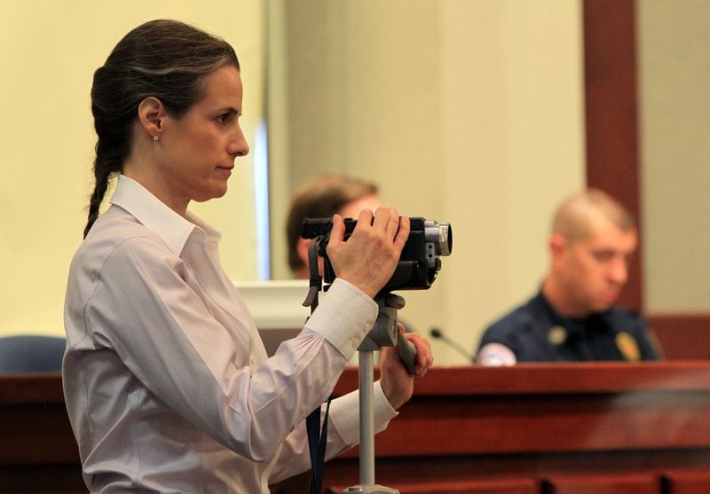 Nydia Tisdale with her camera at the Forsyth County Commission in Cumming in 2011. CURTIS COMPTON / CCOMPTON@AJC.COM