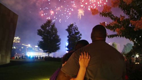A man and woman embrace while watching fireworks in Atlanta. Christina Matacotta/Christina.Matacotta@ajc.com