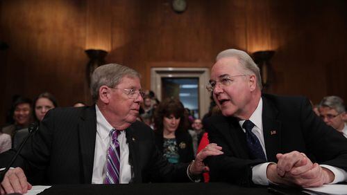 WASHINGTON, DC - Jan. 18, 2017: U.S. Health and Human Services Secretary Nominee Rep. Tom Price (R-GA) (R) talks to Sen. Johnny Isakson (R-GA) (L) during his confirmation hearing on Capitol Hill in Washington, DC. Price, a leading critic of the Affordable Care Act, is expected to face questions about his healthcare stock purchases before introducing legislation that would benefit the companies. (Photo by Alex Wong/Getty Images)