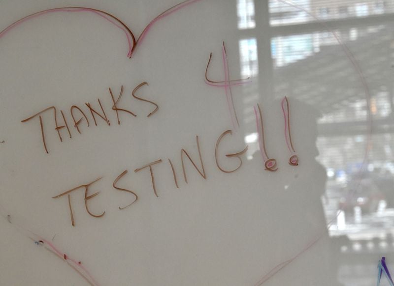 Georgia Tech staff wrote this on a whiteboard for students and employees who come to get tested for COVID-19 at its Economic Development Building on Tuesday, January 4, 2022. (Hyosub Shin / Hyosub.Shin@ajc.com)