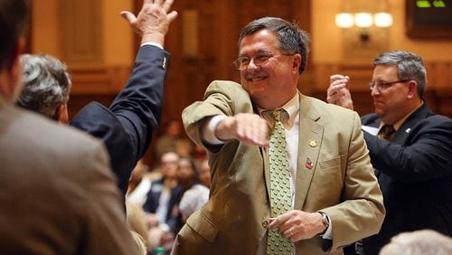 Rep. Rick Jasperse (R-Jasper) celebrates after his gun bill received final passage in the House after 11 p.m. on the last day of the session Thursday evening, March 20, 2014.