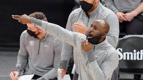 Hawks coach Lloyd Pierce shouts to the team during the second half of an NBA basketball game against the Utah Jazz on Friday, Jan. 15, 2021, in Salt Lake City. (AP Photo/Rick Bowmer)