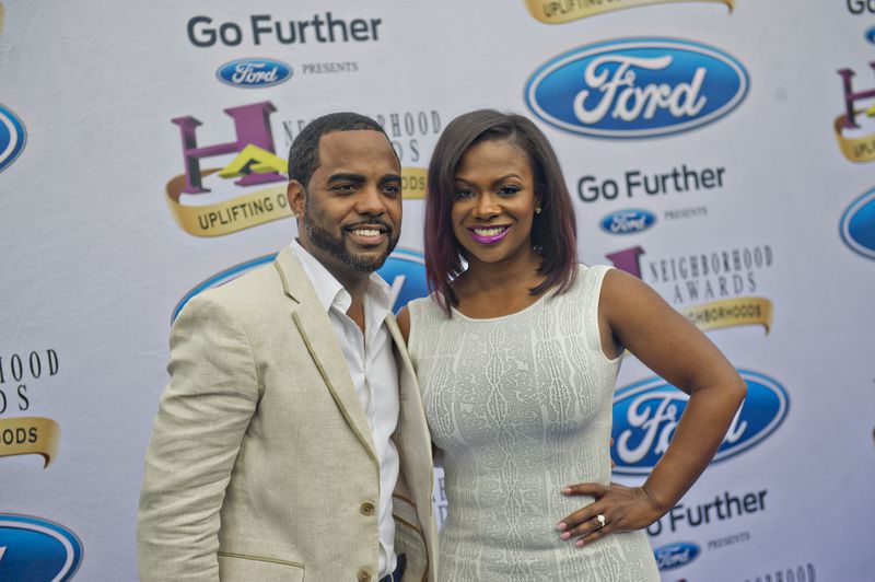 Kandi Burruss (right) and Todd Tucker pose for photos on the blue carpet before the 2014 Ford Neighborhood Awards at Philips Arena in Atlanta on Saturday, August 9, 2014. Steve Harvey hosted the awards. JONATHAN PHILLIPS / SPECIAL