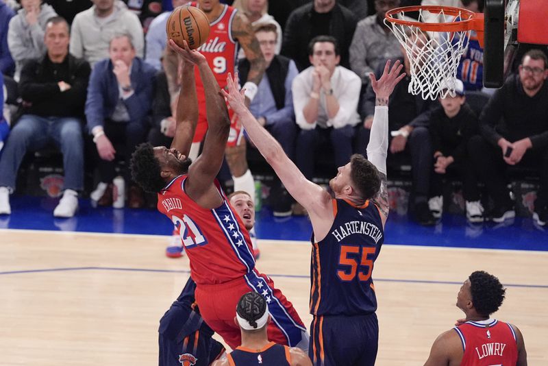 Philadelphia 76ers' Joel Embiid (21) shoots over New York Knicks' Isaiah Hartenstein (55) during the second half of Game 2 in an NBA basketball first-round playoff series Monday, April 22, 2024, in New York. (AP Photo/Frank Franklin II)