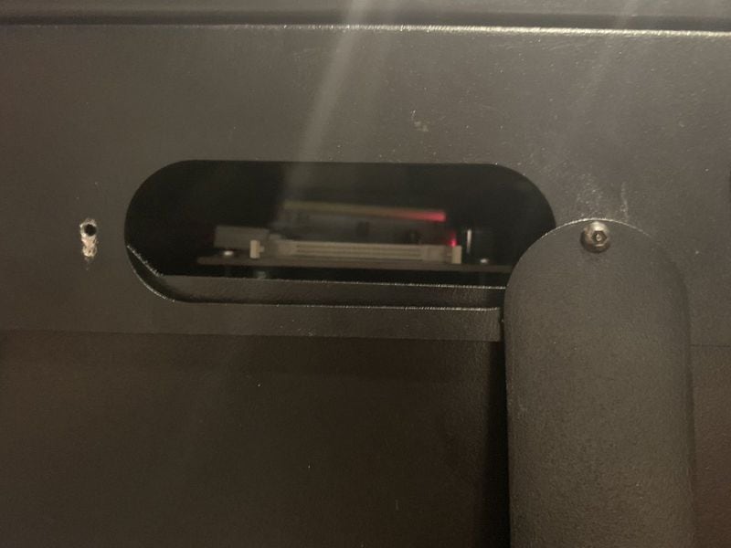 A latch on the side of the Dominion ImageCast Precinct optical scanning machine and ballot box can be opened to access a memory card. Photo credit: DEF CON Voting Machine Hacking Village 2019 report