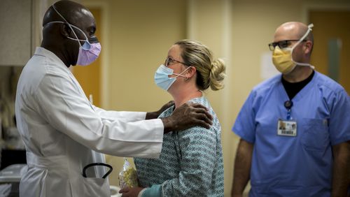 SWAINSBORO, GA - SEPTEMBER 23, 2020: Emergency room physician Dr. Lekan Akinyokunbo, left, speaks with staff member Mary Radford at the Emanuel Medical Center  (AJC Photo/Stephen B. Morton)