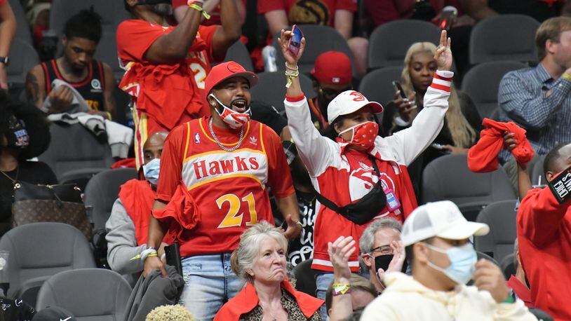 Hawks fans celebrate at the end of the fourth quarter in a NBA basketball game at State Farm Arena on Thursday, October 21, 2021. The Hawks won 113-87 over Dallas Mavericks. (Hyosub Shin / Hyosub.Shin@ajc.com)