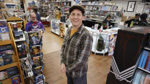 Galactic Quest owner Kyle Puttkammer poses for a photograph at his store in Lawrenceville; he opened the shop over 30 years and said most customers buying toys now are adults. In addition, the items they purchase are often designed more for display than for play, he said.
 Miguel Martinez / miguel.martinezjimenez@ajc.com