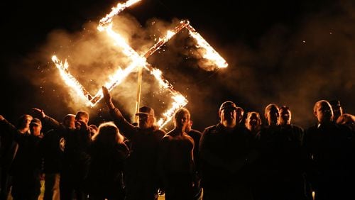 Members of the National Socialist Movement, a neo-Nazi group, hold a swastika-burning in Draketown, Ga., on April 21, 2018, following their rally that day in Newnan, Ga. (Photo by Spencer Platt/Getty Images)