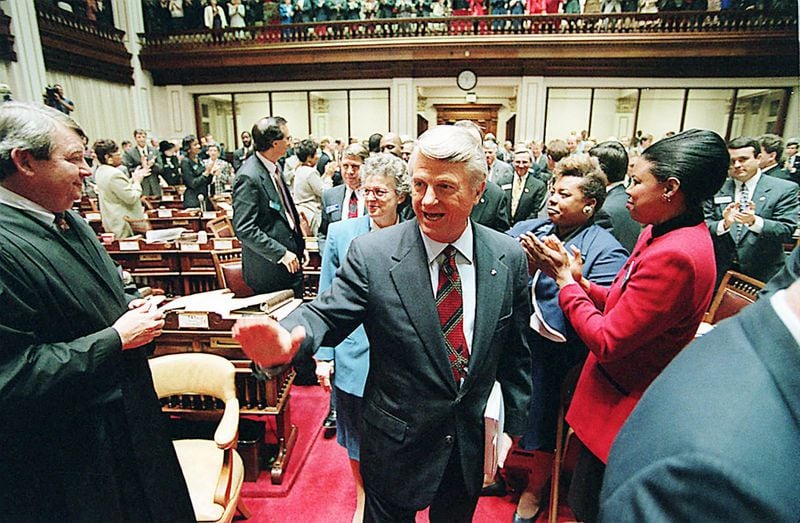 Then-Gov Zell Miller gets an enthusiastic greeting from Georgia lawmakers before his State of the State address in 1991. In his address three years later, the governor promised a crackdown on teen lawbreakers, who he called punks, hoodlums and thugs. AJC File Photo