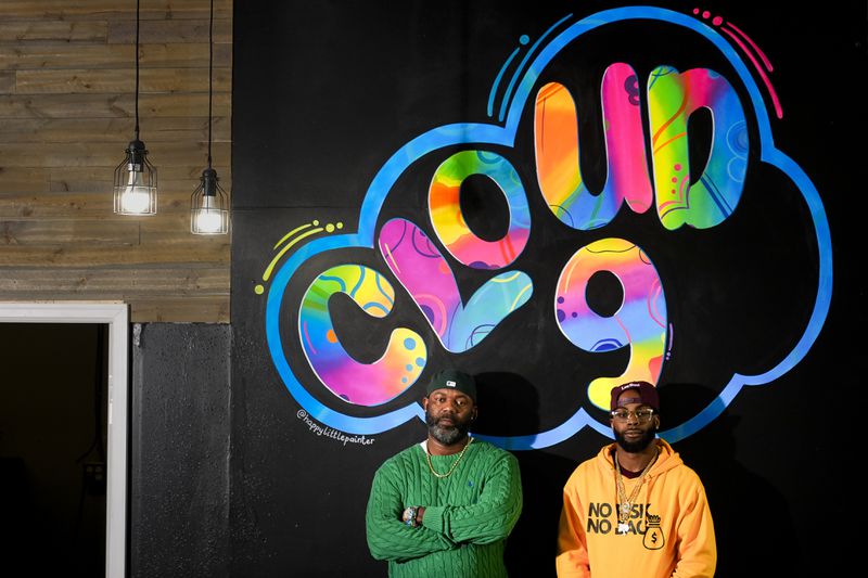 Cloud 9 Cannabis co-owner Dennis Turner, left, and CEO and co-owner Sam Ward Jr., pose at their shop, Thursday, Feb. 1, 2024, in Arlington, Wash. Cloud 9 is one of the first dispensaries to open under the Washington Liquor and Cannabis Board's social equity program, established in efforts to remedy some of the disproportionate effects marijuana prohibition had on communities of color. (AP Photo/Lindsey Wasson)