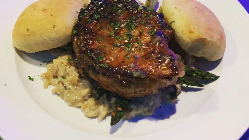 Tomahawk pork chop with apple glaze over mushroom risotto from T-Ray's Fire Grill