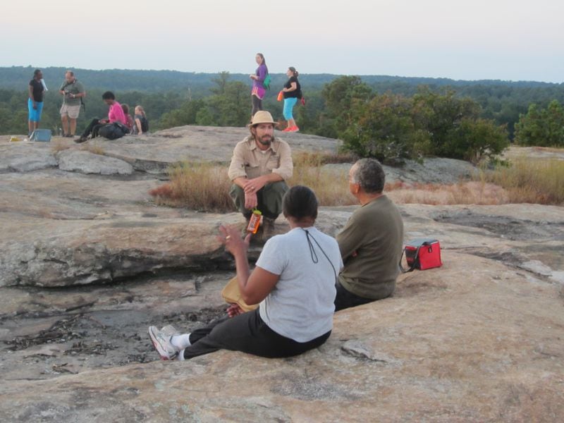 Ranger Robby Astrove chatting with hikers on Arabia Mountain.
Courtesy Arabia Mountain Heritage Area staff