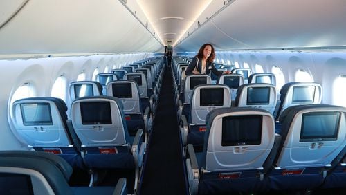 A Delta employee checks out the interior during the unveiling of the new A220 aircraft while celebrating the 10-year anniversary of merging with Northwest at the Delta Air Lines TechOps on Monday, Oct 29, 2018, in Atlanta. Curtis Compton/ccompton@ajc.com