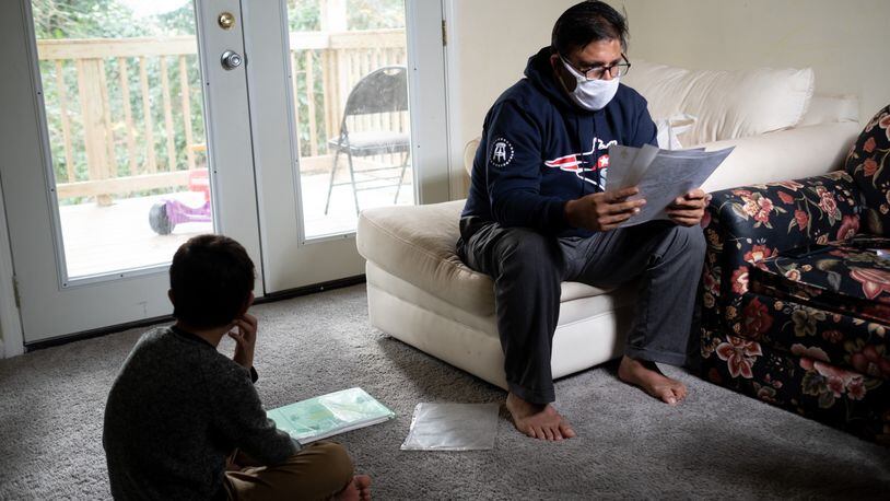 Mohammad, a former member of the Afghan special forces who also worked as a translator for the U.S. military, sorts through recommendation letters he collected from American soldiers and government officials. He and his family have resettled in Decatur. Ben Gray for the Atlanta Journal-Constitution