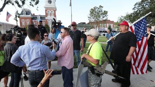 Chris Hill, leader of the III% Georgia Security Force, speaks to the news media during a protest held on the town square Tuesday, Sept. 13, 2016, in Covington against building a mosque in Newton County. Curtis Compton /ccompton@ajc.com