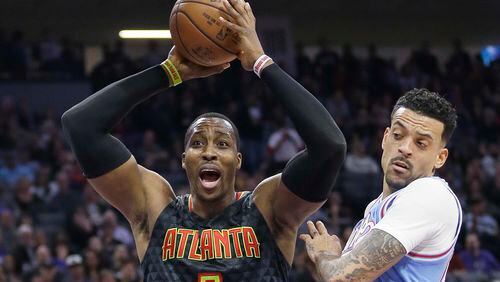 Atlanta Hawks center Dwight Howard, left, reacts after being called for a foul during the first half of the team’s NBA basketball game against the Sacramento Kings on Friday, Feb. 10, 2017, in Sacramento, Calif. At right is Kings forward Matt Barnes. (AP Photo/Rich Pedroncelli)
