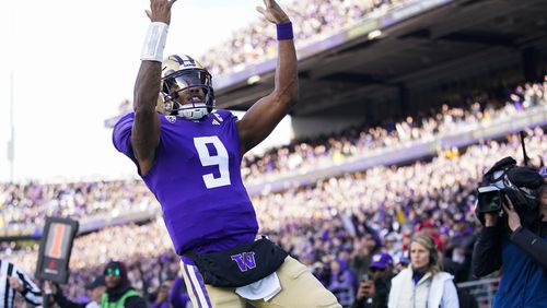 Washington quarterback Michael Penix Jr. reacts after scoring a touchdown against Utah during the first half of an NCAA college football game Saturday, Nov. 11, 2023, in Seattle. (AP Photo/Lindsey Wasson)
