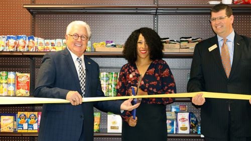 Participating in the recent opening of the 30th school food pantry were (l-r) MUST Ministries President and CEO Dr. Dwight “Ike” Reighard, Garrett Middle School Principal Kimberly Jackson and Drew Shambarger, chairman of the MUST Ministries Board of Directors and the Market President for BB&T Northwest Atlanta. Courtesy of the Cobb County School District