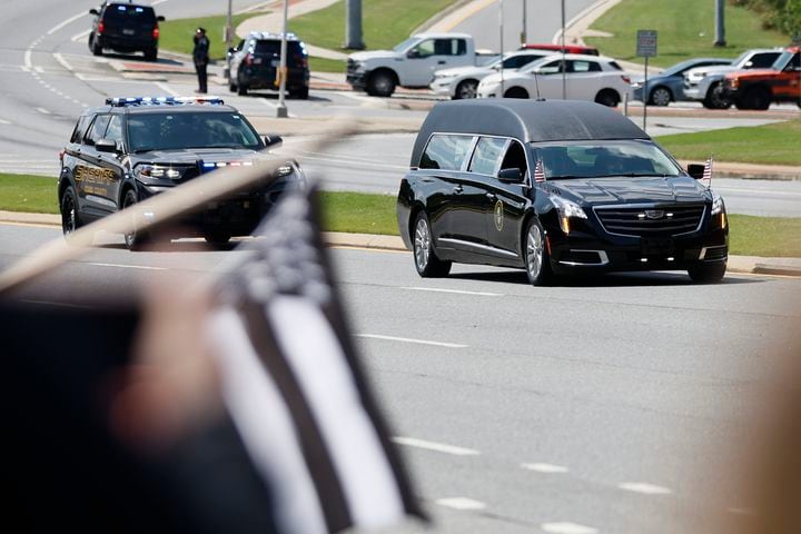 The hearse carrying the casket of fallen Deputy Jonathan Koleski during the procession as they pass by Chastain Rd on their way to the Georgia National Cemetery on Wednesday, September on Wednesday, September 14, 2022. Miguel Martinez / miguel.martinezjimenez@ajc.com