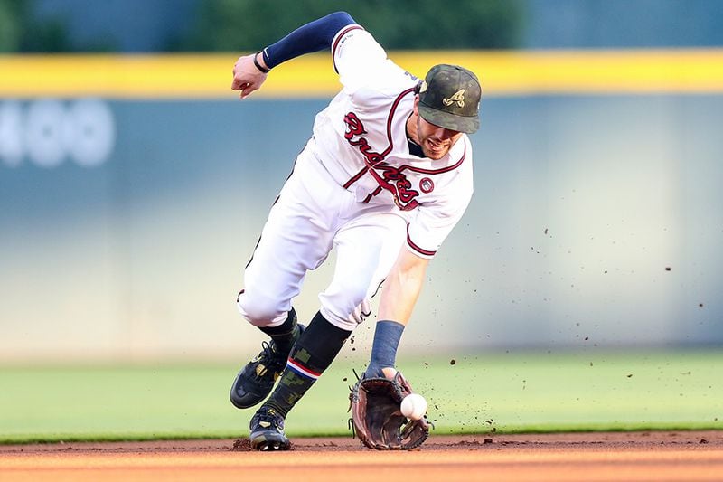 Braves shortstop Dansby Swanson fields a ground ball in the second inning against the Milwaukee Brewers May 18, 2019, at SunTrust Park in Atlanta.